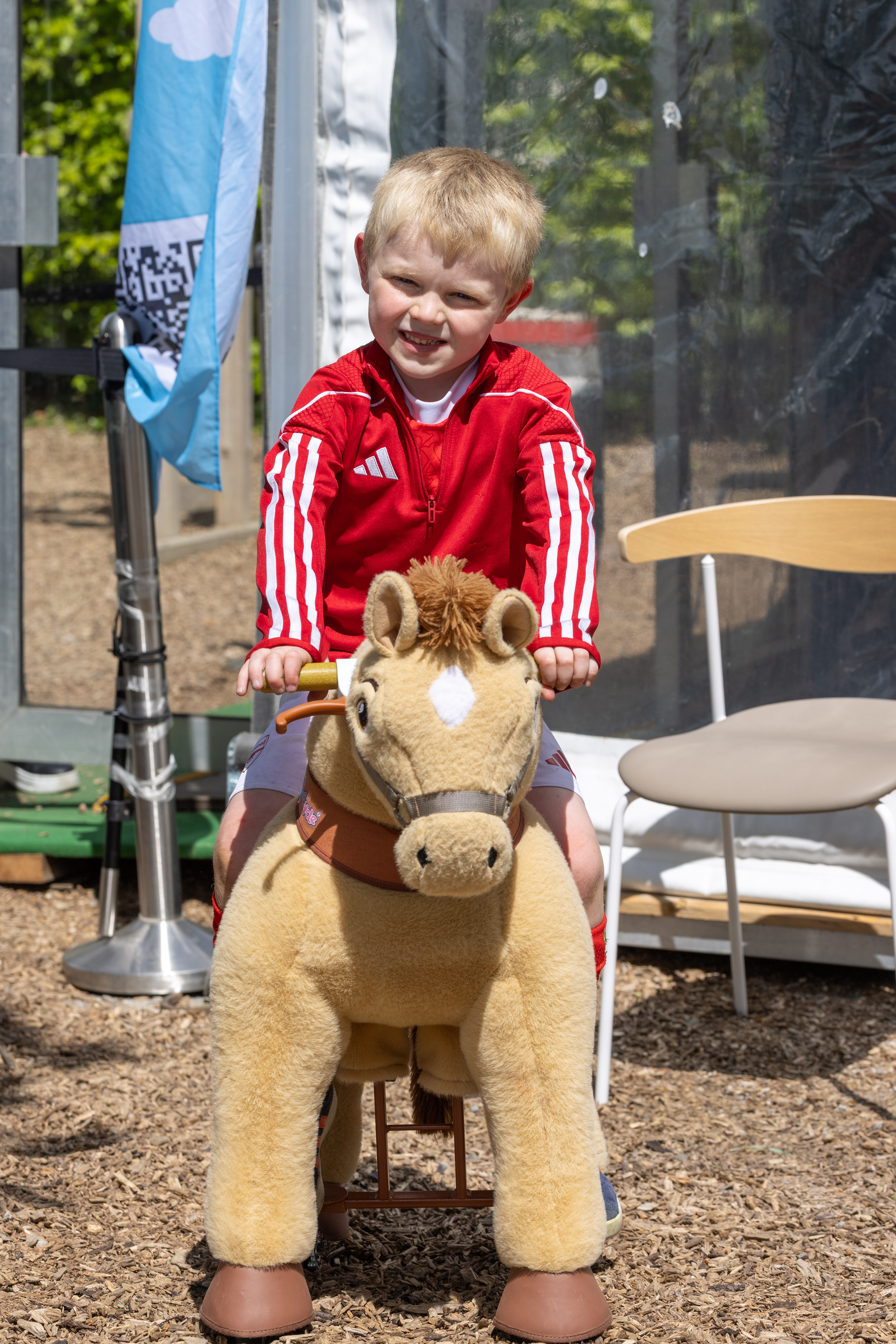 Child on toy horse. 